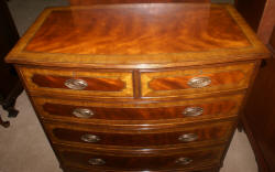 Heavily inlaid mahogany bow front dresser