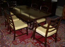 Mahogany Duncan Phyfe dining room table and set of six ribbon back dining room chairs