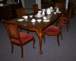 solid cherry dining room table and six cane back dining room chairs